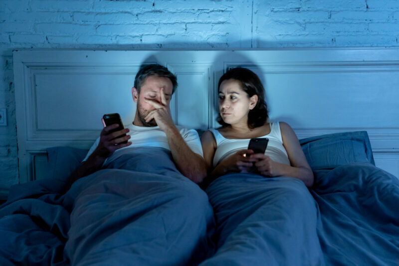blue light of smartphone screens shining in bedroom