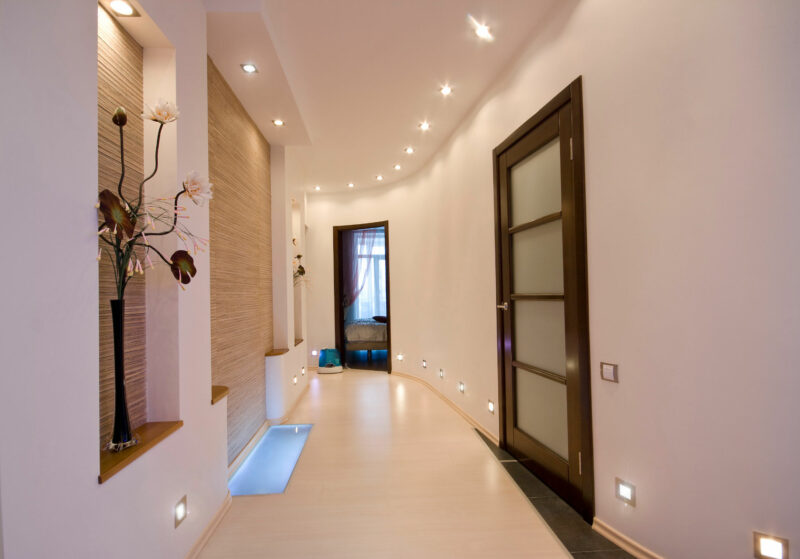 well lit hallway with recessed lighting