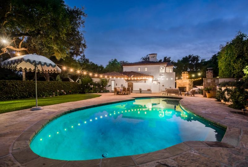 Hanging String Lights over Large Outdoor Pool in the Backyard