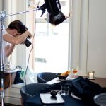 Man photographing food and wine on table