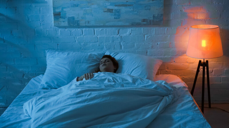 woman sleeping with light switch on